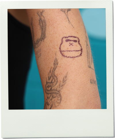 Sonny tattoo on a person's arm with a blue background